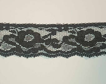 May include: Black lace trim with a floral pattern.