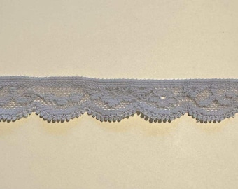 May include: A length of light gray lace trim with a scalloped edge. The lace has a delicate floral pattern and is suitable for various craft projects. The trim is approximately 1 inch wide.