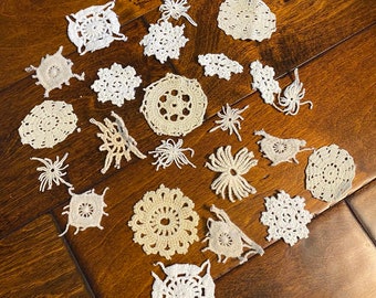 May include: A collection of 20 white crocheted doilies of various sizes and patterns.