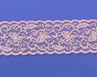 May include: Pink lace trim with a delicate floral pattern. The lace is soft and has a slightly shimmery finish.