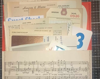 May include: A handmade paper pocket filled with vintage ephemera. The pocket is made from sheet music and stitched with brown thread. Contents include index cards, tags, and printed ephemera with text and numbers.