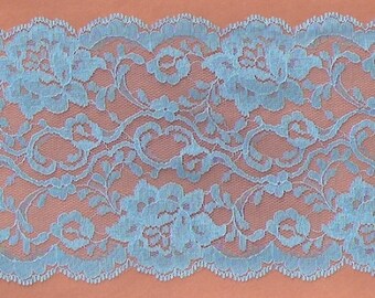 May include: Light blue lace trim with a scalloped edge. The lace has a floral pattern.
