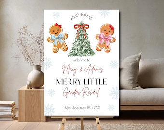 May include: A white sign on an easel with the text "what's baking?" and "Macy & Adam's MERRY LITTLE Gender Reveal". The sign features gingerbread people and a Christmas tree illustration. The date "friday, december 19th, 2025" is also displayed.