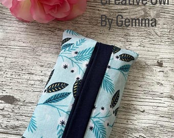 May include: A light blue tissue box cover with a navy blue flap and a white and gold leaf pattern. The text "Creative Owl By Gemma" is visible in the background.