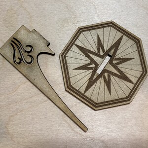 Puede incluir: Una base de madera en forma de estrella con un recorte en el centro y un soporte de madera con un dise&ntilde;o decorativo. El soporte est&aacute; dise&ntilde;ado para sostener un objeto peque&ntilde;o, como una vela o una figurita.