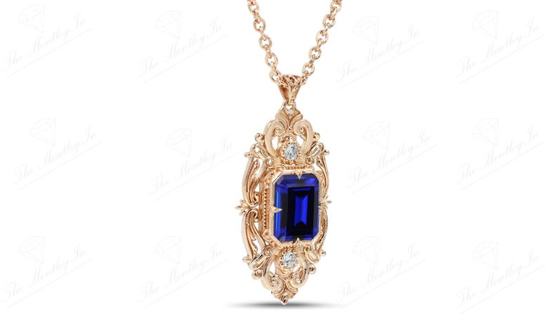 May include: A gold pendant necklace with a blue gemstone surrounded by smaller diamonds in a detailed ornate design.