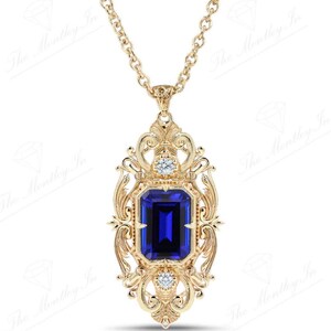 May include: A gold pendant necklace with a large blue sapphire gemstone surrounded by smaller diamonds. The pendant features an intricate, ornate design.