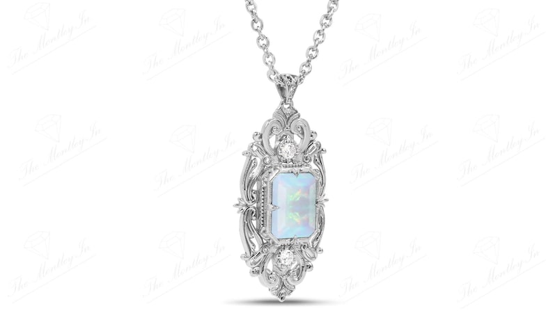 May include: A silver pendant necklace with a white opal gemstone set in a detailed filigree design.