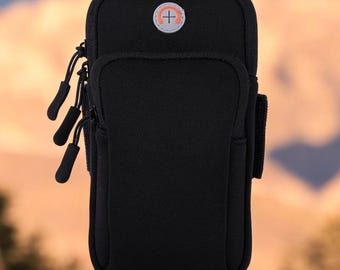 May include: Black phone armband with a zip closure and a small orange logo. The armband has a strap to secure it to your arm.