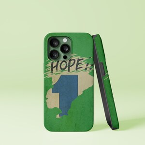 May include: Green phone case with a white and blue graphic of the number one and the word "HOPE!" in black. The case is designed for a phone with a triple lens camera.