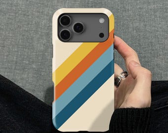 May include: A phone case with a cream-colored border and a retro design. The case features diagonal stripes in yellow, orange, blue, and navy blue. The phone's camera lenses are visible at the top.