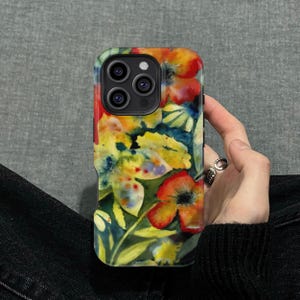 May include: A floral phone case featuring a watercolor design with red, yellow, and green flowers. The case has a glossy finish and a camera cutout.