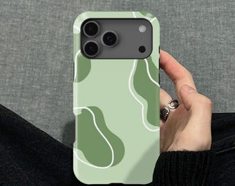 May include: A light green phone case with a pattern of abstract shapes in darker green and white. The phone case has a camera cutout and is held by a person.