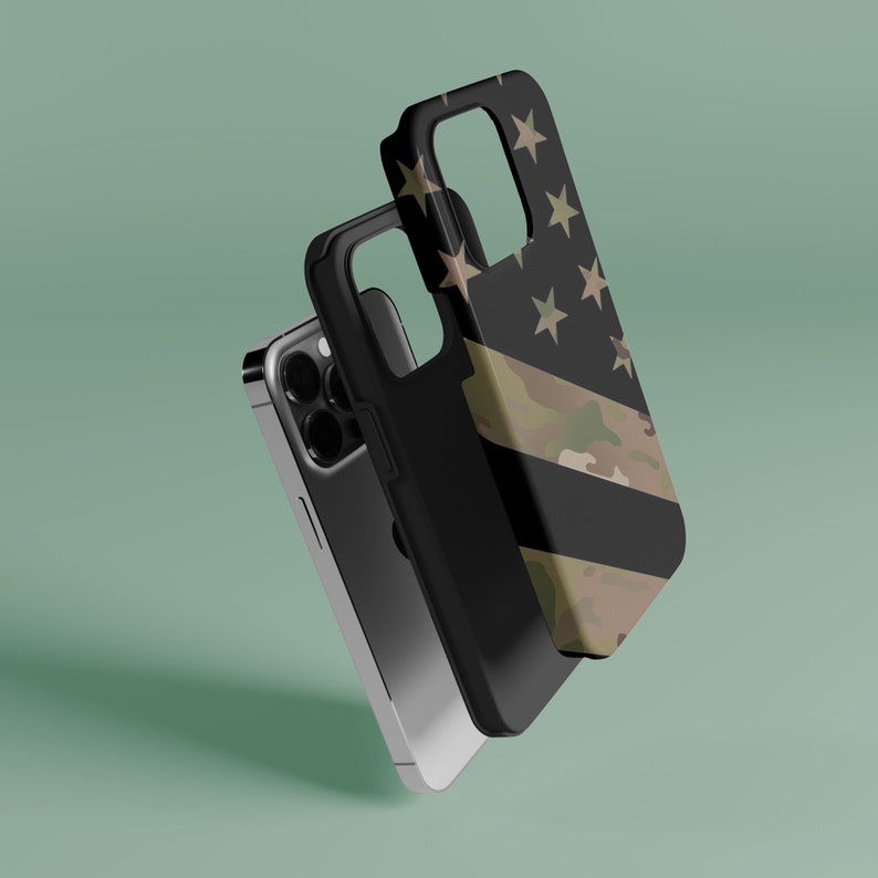 May include: A black phone case with a camouflage and American flag design. The case is shown with a black phone inside.