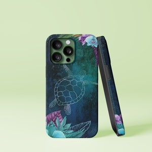 May include: A phone case with a sea turtle design. The case features a dark blue and teal background with a white outline of a sea turtle. Tropical leaves and flowers in shades of purple, blue, and green decorate the case.