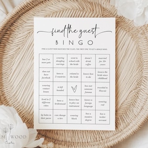 May include: A white "Find the Guest Bingo" game card with black text, featuring a grid of prompts. The card is on a woven tray. The game is designed to find guests who match the clues. The Elm Wood Crate logo is at the bottom.