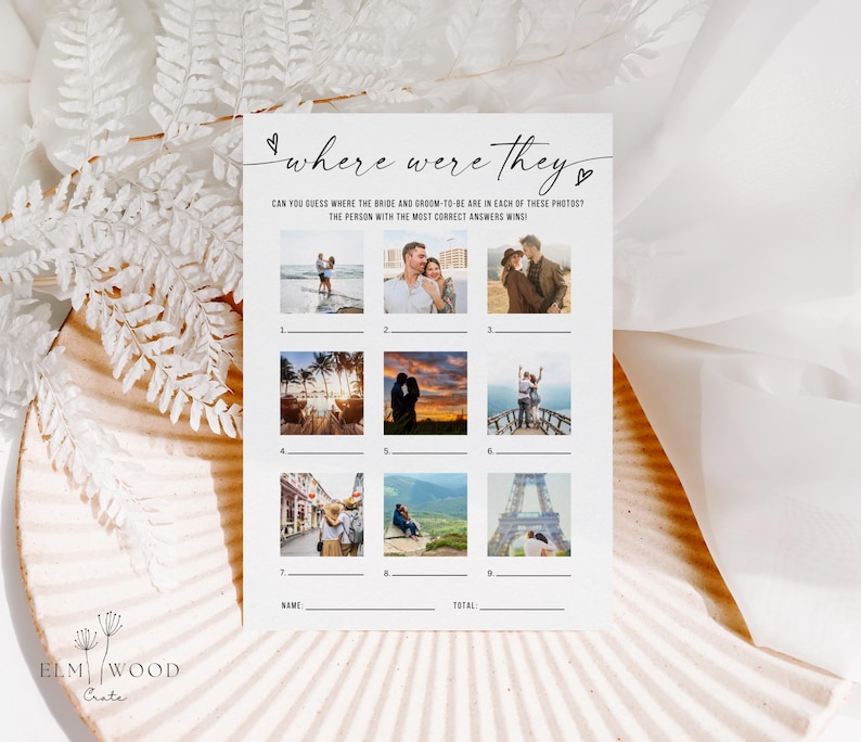 May include: A white card with the text "where were they" and the phrase "CAN YOU GUESS WHERE THE BRIDE AND GROOM-TO-BE ARE IN EACH OF THESE PHOTOS? THE PERSON WITH THE MOST CORRECT ANSWERS WINS!". The card has nine photo slots and lines for name and total.