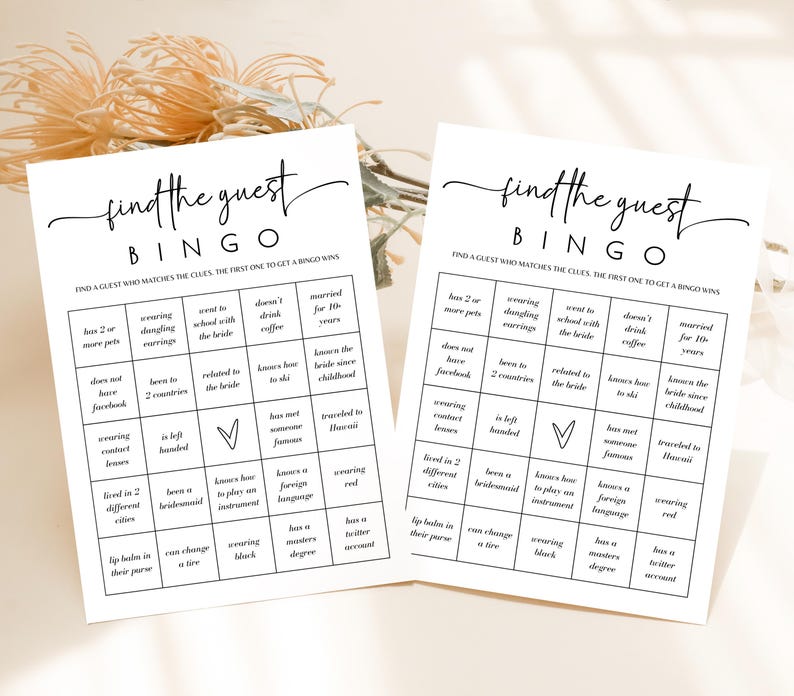 May include: Two white bingo cards with black text that reads "find the guest BINGO". The cards have a grid of clues to match guests. The cards are for a bridal shower game.