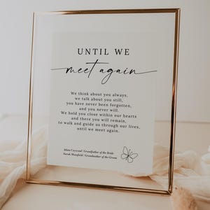 May include: A framed print with a gold frame and a white background. The print features a quote about remembering loved ones who have passed away. The quote reads "Until we meet again. We think about you always, we talk about you still, you have never been forgotten, and you never will. We hold you close within our hearts and there you will remain, to walk and guide us through our lives, until we meet again." The print also includes the names "Adam Caywood" and "Surah Mansfield" and a small butterfly illustration.