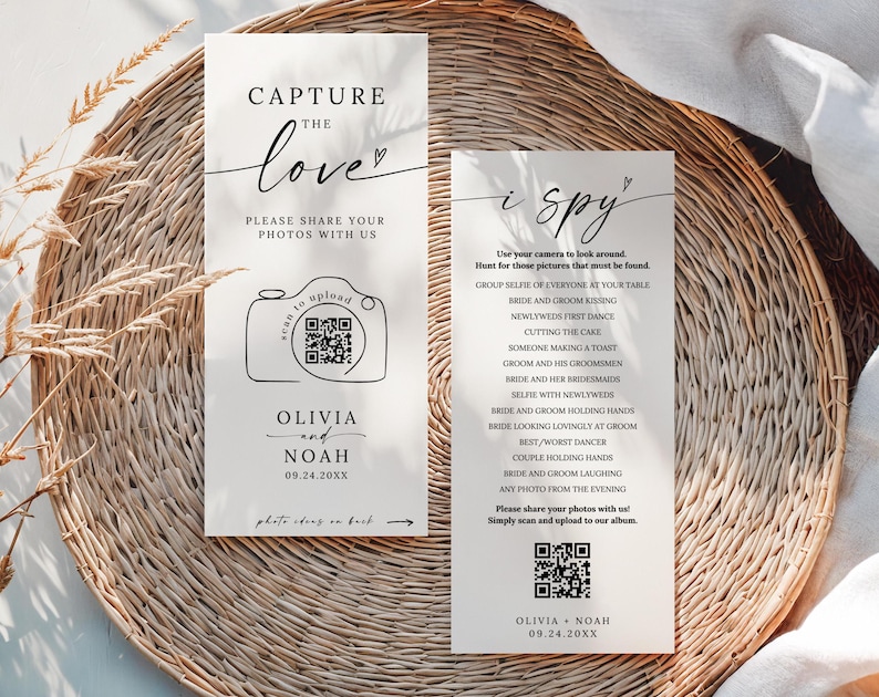 May include: Two rectangular wedding signs with text. One says "Capture the love" with a camera graphic and QR code. The other says "i spy" with a list of photo prompts and a QR code. Both signs include the names Olivia and Noah and a date.