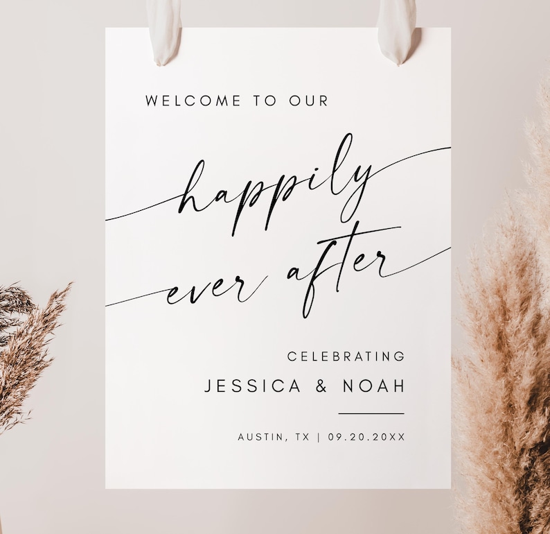 May include: A white wedding welcome sign with the words "WELCOME TO OUR" at the top. The phrase "happily ever after" is written in elegant script. The sign also includes the names "JESSICA & NOAH" and the city and date.