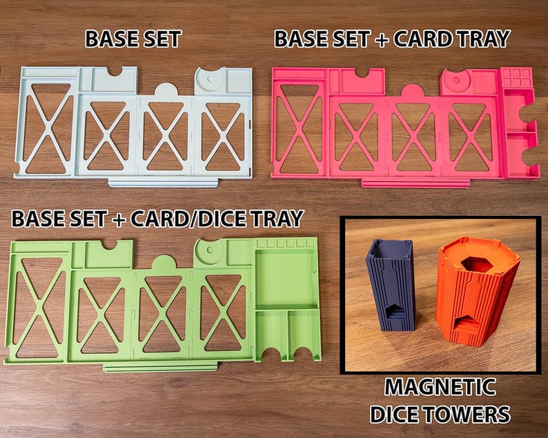May include: A light blue base set, a pink base set with a card tray, a light green base set with a card and dice tray, and a dark blue and orange magnetic dice tower. The text BASE SET, BASE SET + CARD TRAY, BASE SET + CARD/DICE TRAY, and MAGNETIC DICE TOWERS are visible.