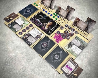 May include: A wooden game board with a black and white design. The board has spaces for cards, dice, and tokens. The board is labeled "Angela".
