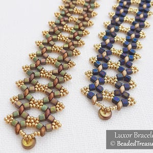 May include: Two beaded bracelets. One is olive green and brown, the other is navy blue and gold. Both have a geometric design with small, cube-shaped beads and gold accents. The bracelets are displayed on a white surface. Text on the image reads "Luxor Bracelet" and "BeadedTreasury".