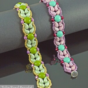 May include: Two beaded bracelets with a tulip band design. One bracelet features green, gold, and purple beads. The other bracelet has pink, turquoise, and red beads. The bracelets are approximately 7 inches long.