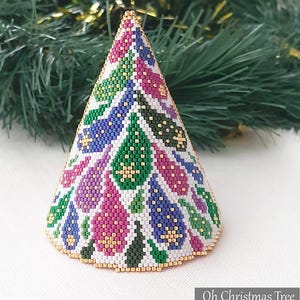 May include: A beaded Christmas tree ornament with a conical shape. The tree is decorated with a pattern of pink, green, blue, and gold beads. The base and top are trimmed with gold beads. The text "Oh Christmas Tree" and "Beaded Treasury 2021" are visible.