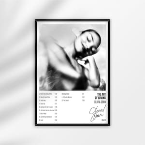 May include: Monochrome framed poster with a blurred image of a person. The poster displays the text "THE ART OF LOVING" and the artist's name, Olivia Dean, alongside a list of song titles and timings.
