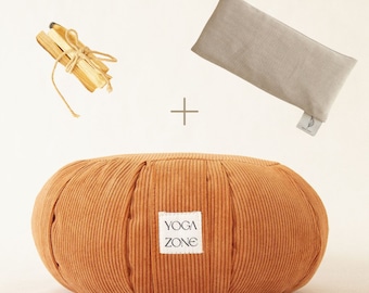 The Meditator Kit, a pink meditation pillow, 4 Palo Santo sticks and a lavender eye pillow