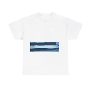 May include: White t-shirt with a blue and white image of a snow-covered bench and the text "silence - the power of falling".