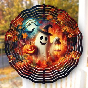May include: A metal wind spinner with a Halloween theme. The design features a ghost holding a lantern, a jack-o-lantern, and autumn leaves. The spinner is painted in shades of orange, red, yellow, and black.