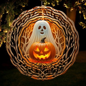 May include: A white ghost with a jack-o'-lantern face is inside a wooden wreath with a black and white tree design. The wreath is hanging from a tree branch.