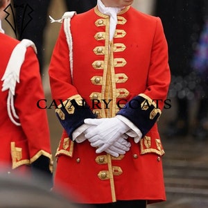 May include: A red military-style coat with gold trim and buttons. The coat has a high collar and a double-breasted closure. The sleeves have black velvet cuffs.