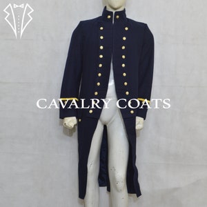 May include: A long, dark blue coat with gold buttons and yellow trim on the cuffs. The coat has a high collar and a single-breasted closure. "CAVALRY COATS" is printed in white letters on the front of the coat.
