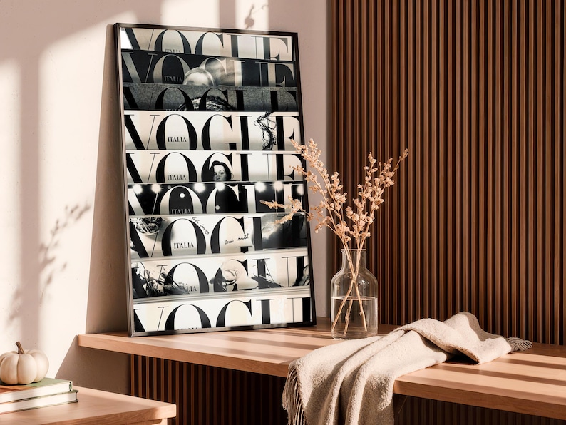 May include: A rectangular framed wall art print featuring a collage of black and white Vogue Italia magazine covers stacked horizontally. The artwork displays the bold, repeating Vogue logo in black typography against a white background.