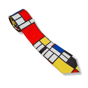 May include: A colorful necktie featuring a geometric design in red, yellow, blue, black, and white. The tie is a classic accessory, perfect for adding a pop of color to any outfit. The design is reminiscent of modern art.