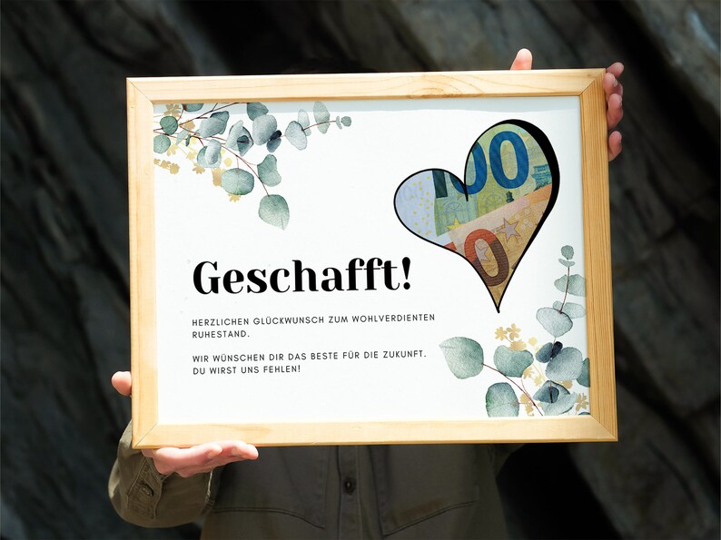 May include: A framed white card with the text "Geschafft!" and a heart-shaped cutout filled with euro bills. The card also includes the text "Herzlichen Gl&uuml;ckwunsch zum wohlverdienten Ruhestand. Wir w&uuml;nschen dir das Beste f&uuml;r die Zukunft. Du wirst uns fehlen!" and a watercolor illustration of eucalyptus leaves.