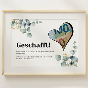 May include: A framed print with a white background and a black heart shape filled with euro bills. The text "Geschafft!" is in black bold font. The text below the heart reads "Herzlichen Gl&uuml;ckwunsch zum wohlverdienten Ruhestand. Wir w&uuml;nschen dir das Beste f&uuml;r die Zukunft. Du wirst uns fehlen!"
