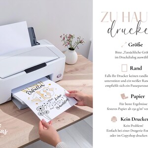 May include: A white printer is shown printing a birthday card with the text "Wunsch Erf&uuml;lter 18 Alles Liebe Geburtstag". The card has a gold and black design with dandelion illustrations. The image also includes text about printing at home.