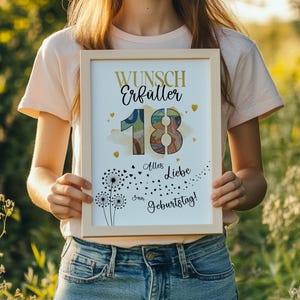 May include: A framed print with the text "Wunsch Erf&uuml;ller 18 Alles Liebe zum Geburtstag!" in gold and black. The print features a colorful "18" design, hearts, and dandelion illustrations. The frame is light-coloured.