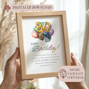 Puede incluir: Una impresión enmarcada con un marco de madera clara. La impresión presenta una ilustración de acuarela de globos que forman el número 80. Las palabras "Happy Birthday!" están escritas en una fuente de escritura, con texto adicional debajo. Las palabras "DIGITALER DOWNLOAD" y "SOFORT NACH KAUF VERFÜGBAR" también son visibles.