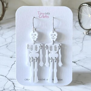 Halloween skeleton earrings, spooky jewelry, novelty gift, goth accessories, wiggly joints, 2.75-inch length, 0.80-inch width, stainless steel, festive fall gift, gift for her, gift for mom.