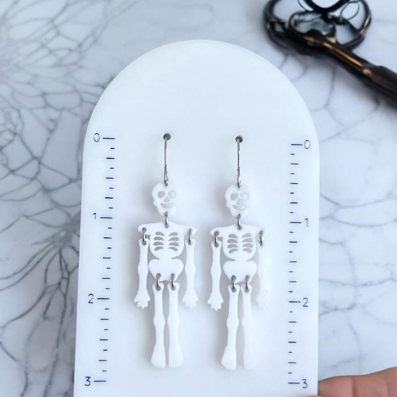 Spooky skeleton earrings, Halloween jewelry, novelty gift, wiggly joints, 2.75-inch long, 0.80-inch wide, goth style, stainless steel, gift for women, festive fall jewelry.