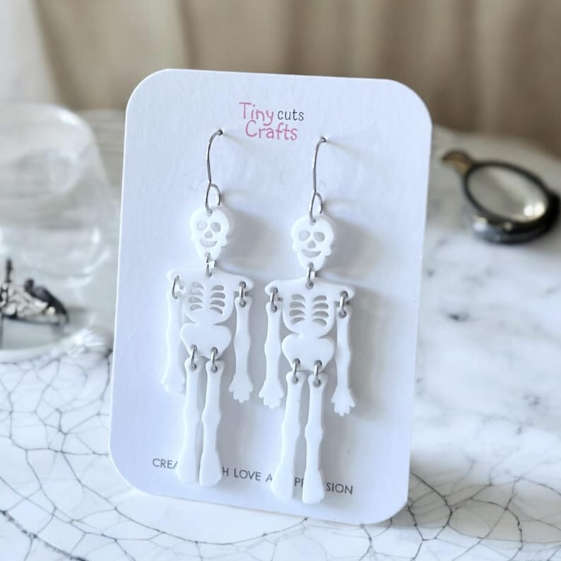 Spooky Halloween skeleton earrings, novelty goth jewelry, wiggly joints, 2.75-inch long, 0.80-inch wide, stainless steel, festive gift, gift for friend, gift for women.