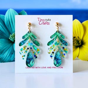 Tiered Tropical Leaf Earrings: glitter acrylic dangles with teal botanical pattern for summer style