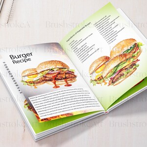 Op de afbeelding: Open kookboek met een recept voor een vegetarische burger. De pagina toont een aquarel-illustratie van een burger met een gebakken ei, avocado, tomaat, ui en sla. De ingredi&euml;ntenlijst bevat een verscheidenheid aan groenten, waaronder tomaten, komkommers en uien.