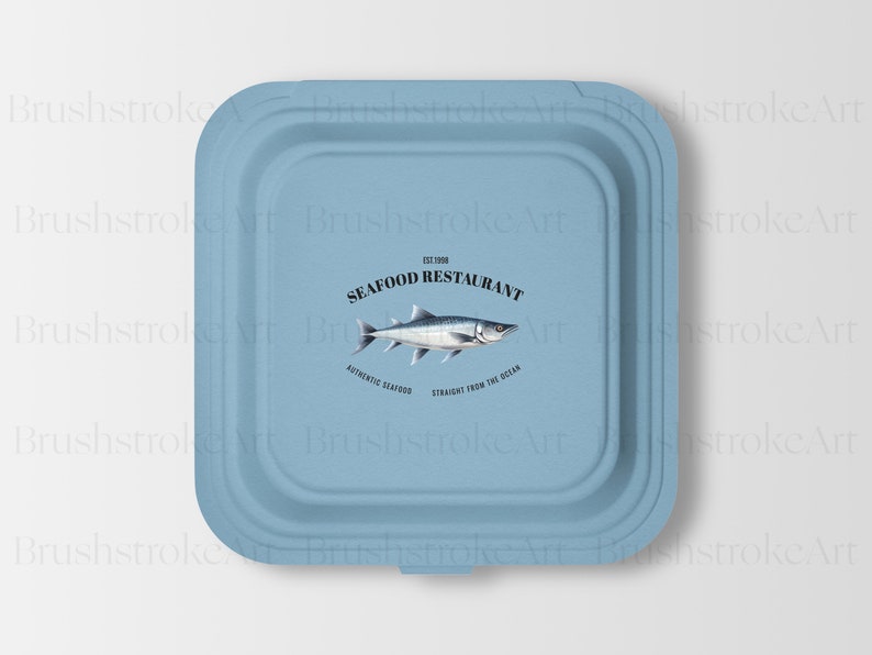 Puede incluir: Un recipiente de papel azul para llevar con un logotipo de restaurante de mariscos. El logotipo presenta una ilustraci&oacute;n de pescado y el texto "The Fish Seafood Restaurant", "Authentic Seafood" y "Straight from the Ocean".